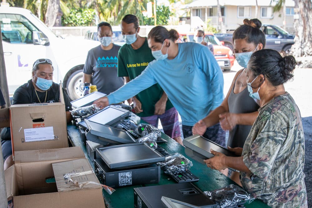 Photo of Kuauli Digital Opportunities Initative volunteers with computer equipment