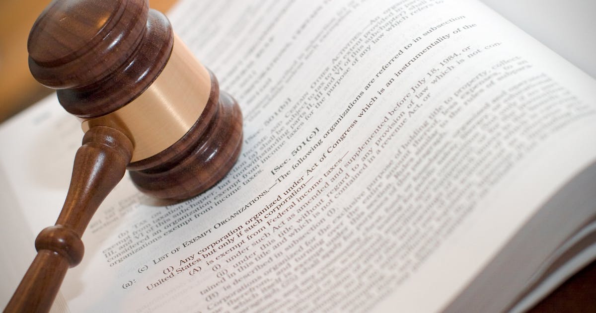 Photo of gavel in front of law book open to section to 501(c)