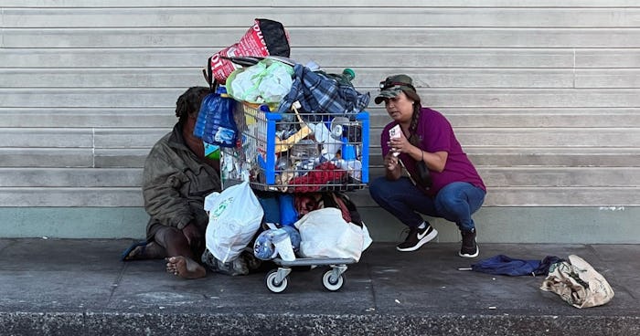Photo of Brandee Menino consulting with a person experiencing homelessness.