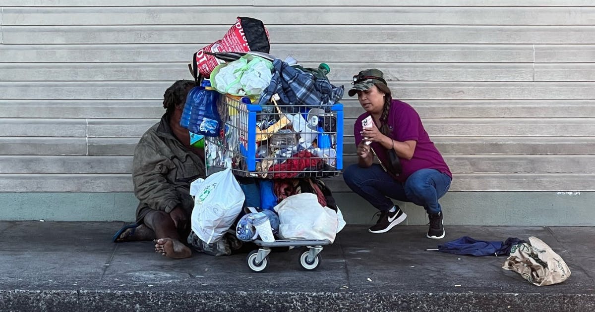 Photo of Brandee Menino consulting with a person experiencing homelessness.