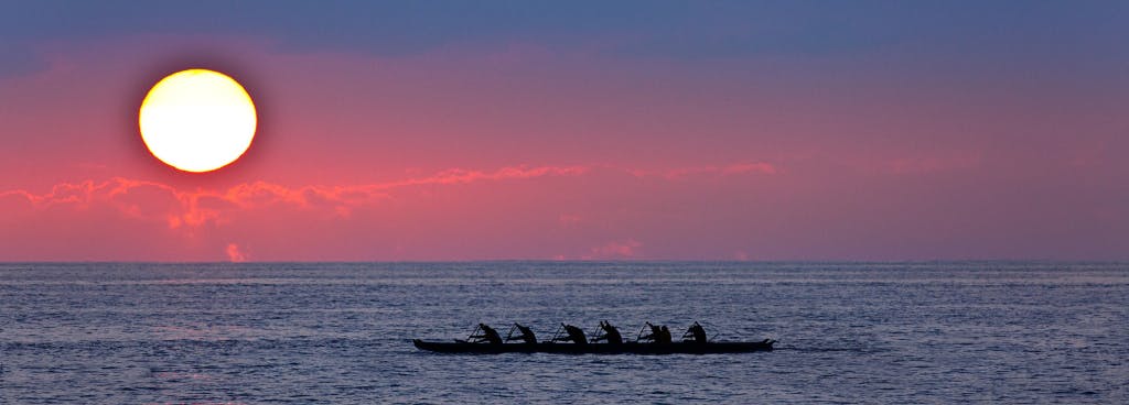Photo of canoe paddlers on the ocean