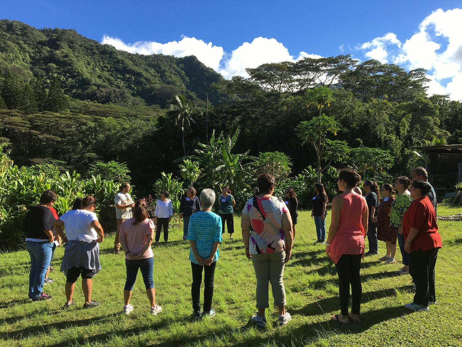 Photo of a group of people outdoors standing in a circle