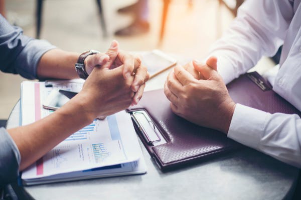 Photo of hands during a business meeting.