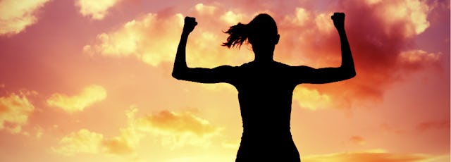 Photo of a silhouetted woman flexing her arms and showing strengths