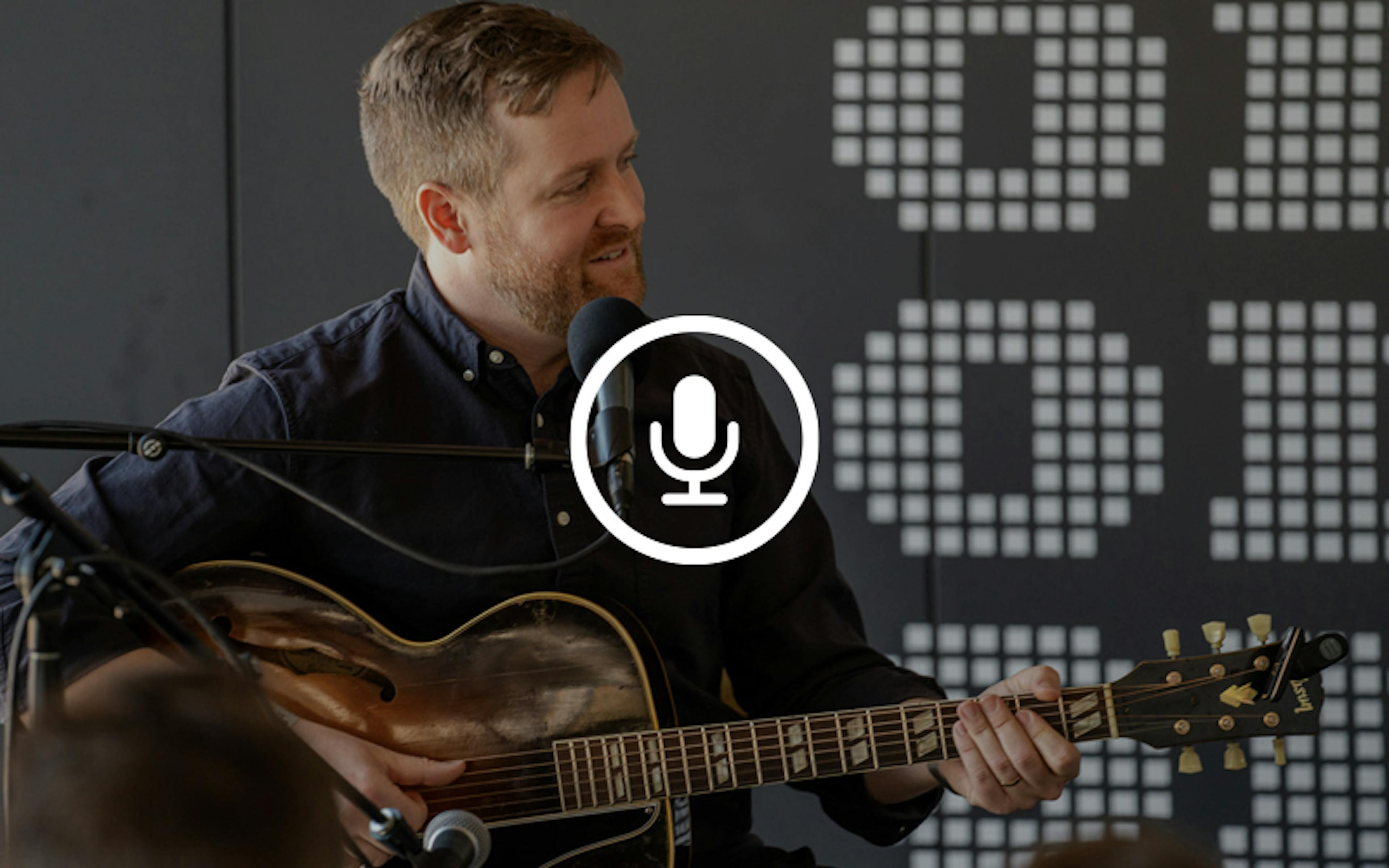 Charlie Harding, host of Switched On Pop, playing the guitar at On Air Fest 2024.