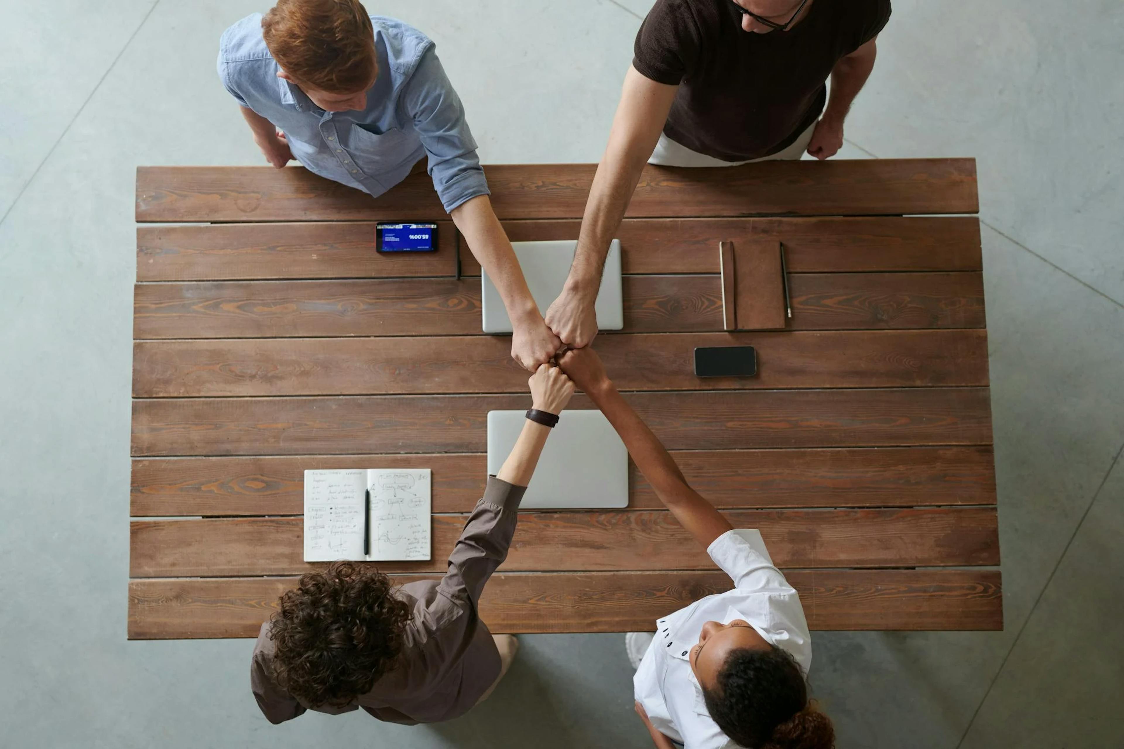 image of a team fist bumping each other