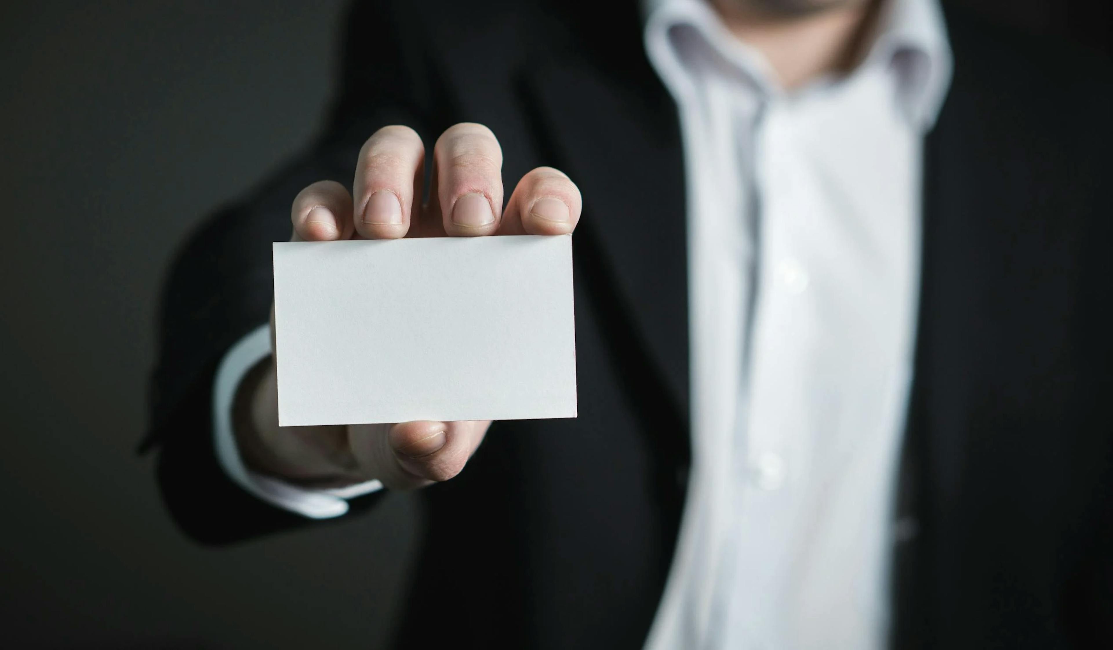 image showing a person putting out a blank card up front