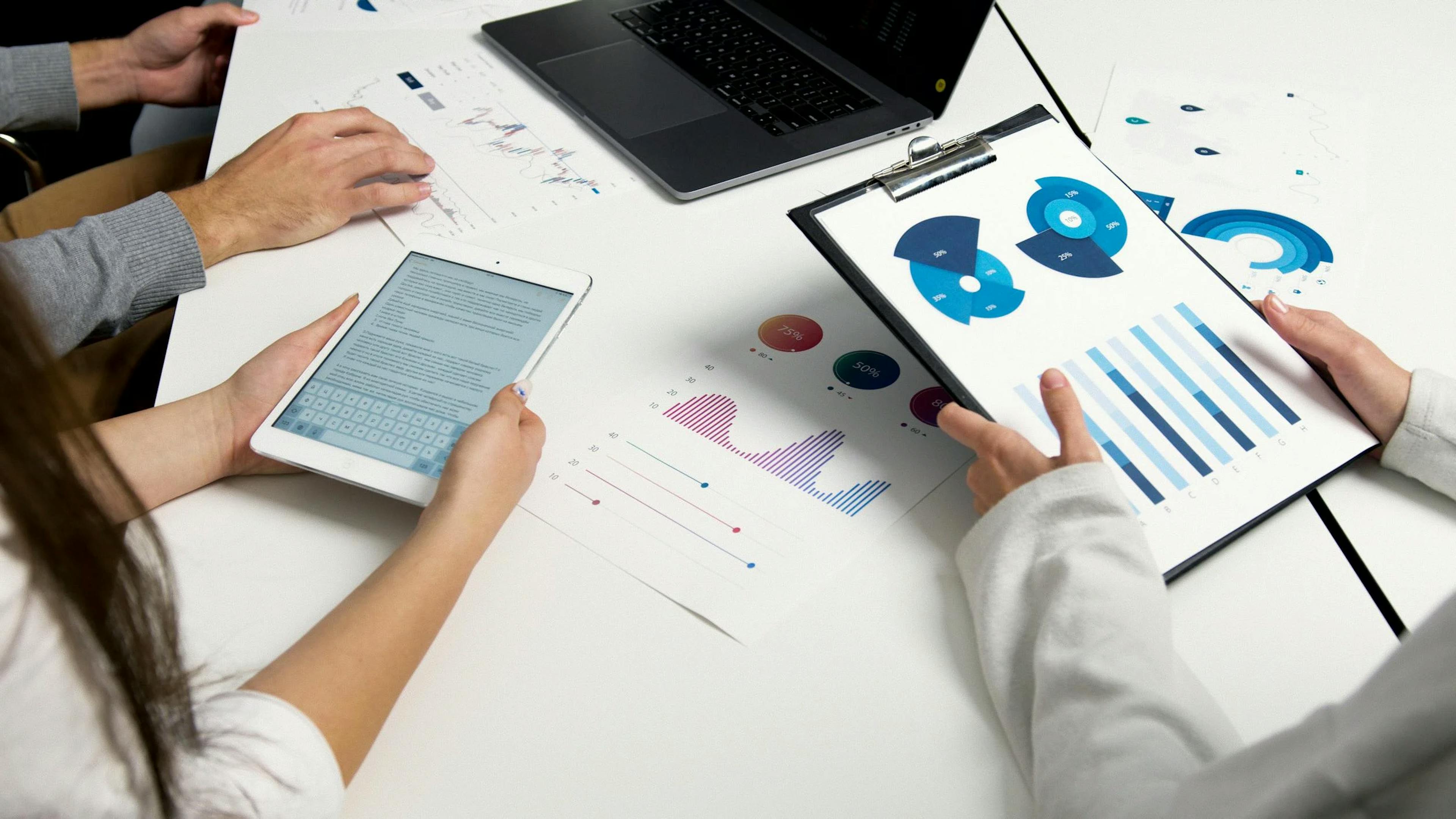 image showing people in a meeting discussing over some charts