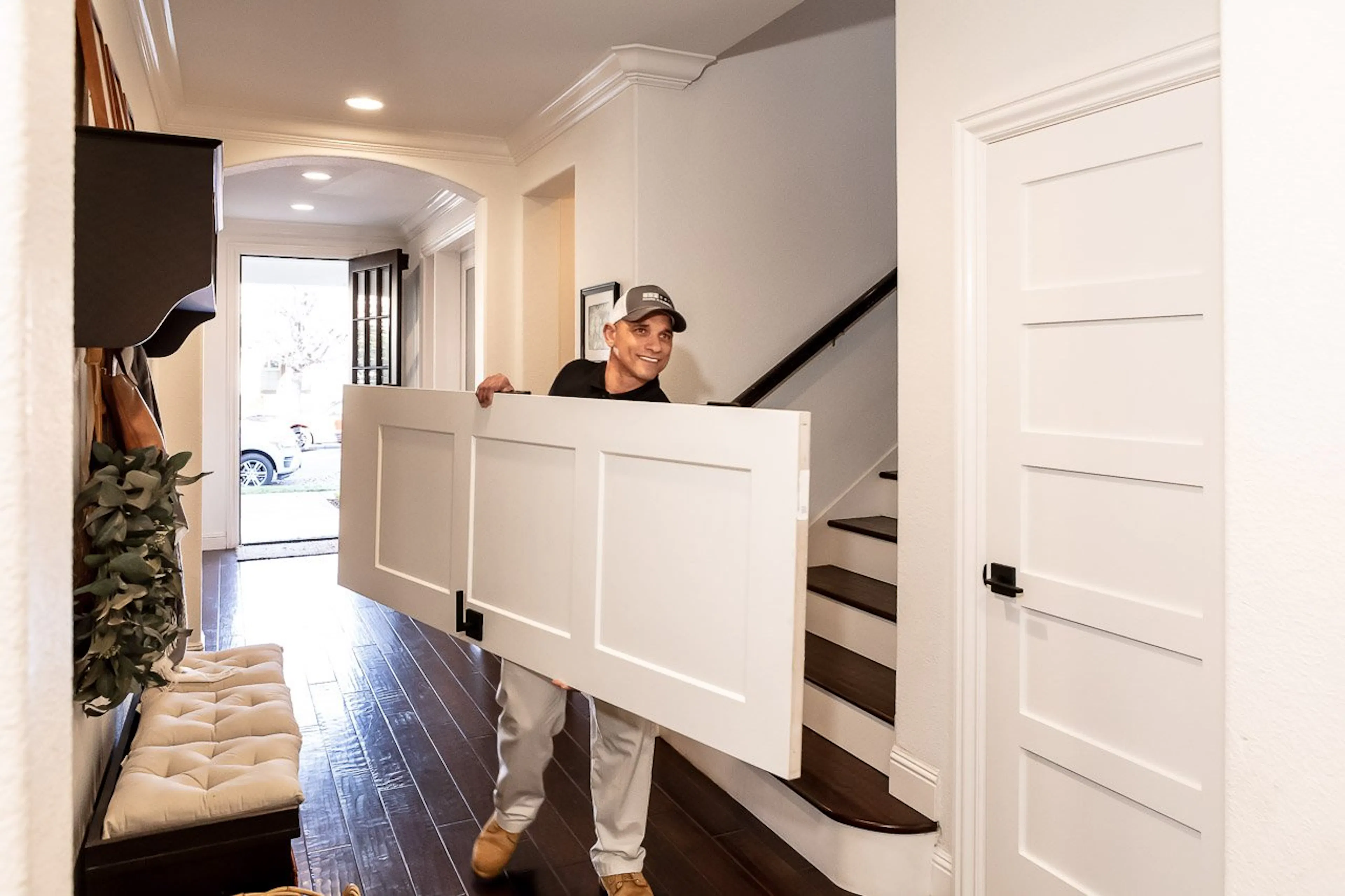 Installer carrying a door to its install location.