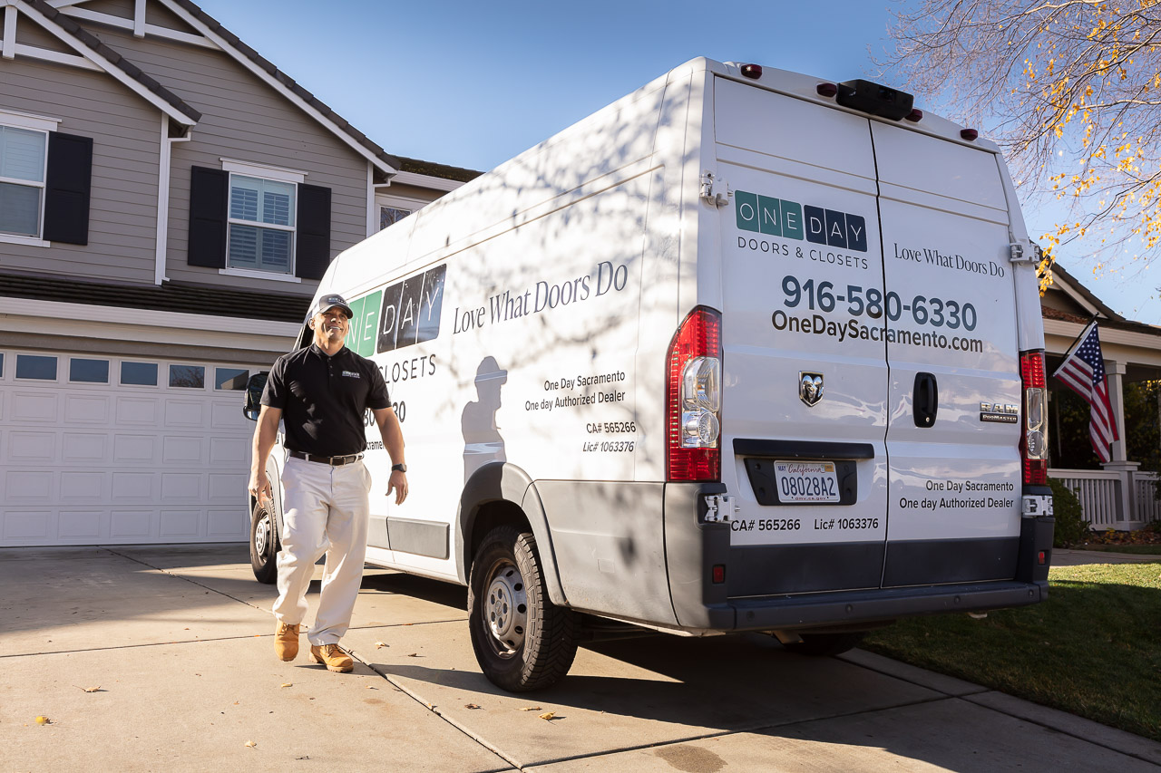 One day doors installer and van on a residential driveway.