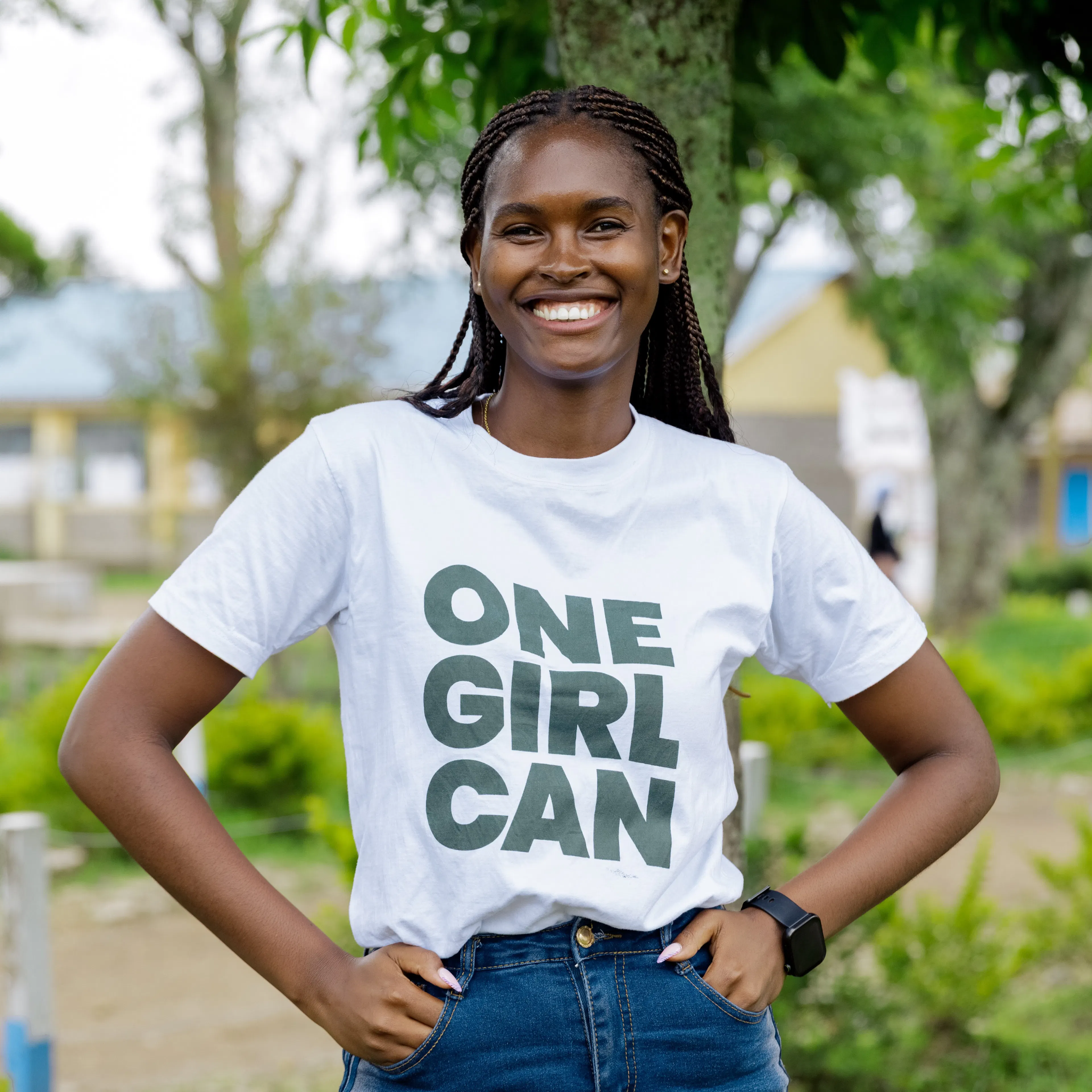 Purity Munyi, One Girl Can graduate and Senior Program Director, wearing a One Girl Can t-shirt