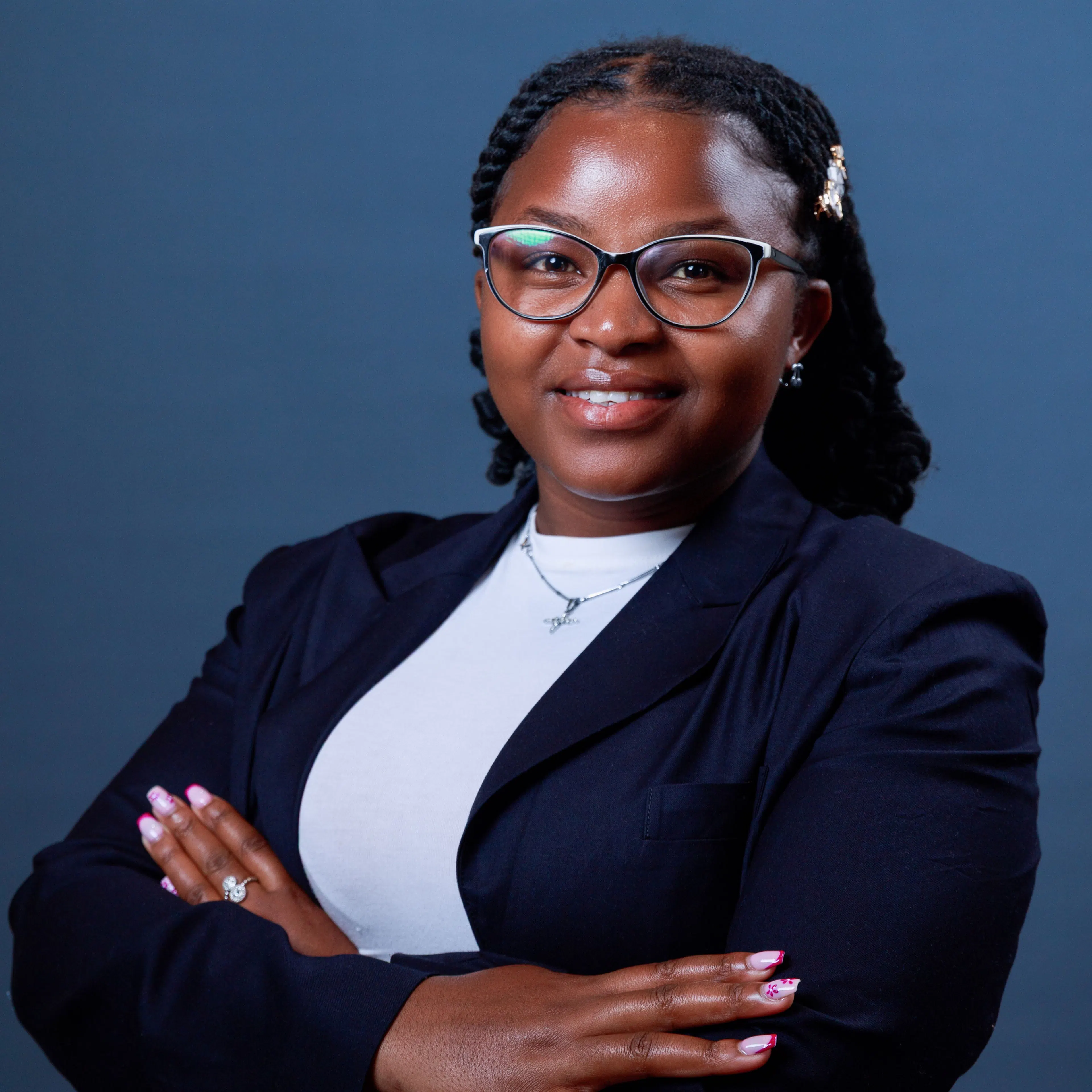 Portrait of Wincate, a One Girl Can university graduate, in a navy blazer