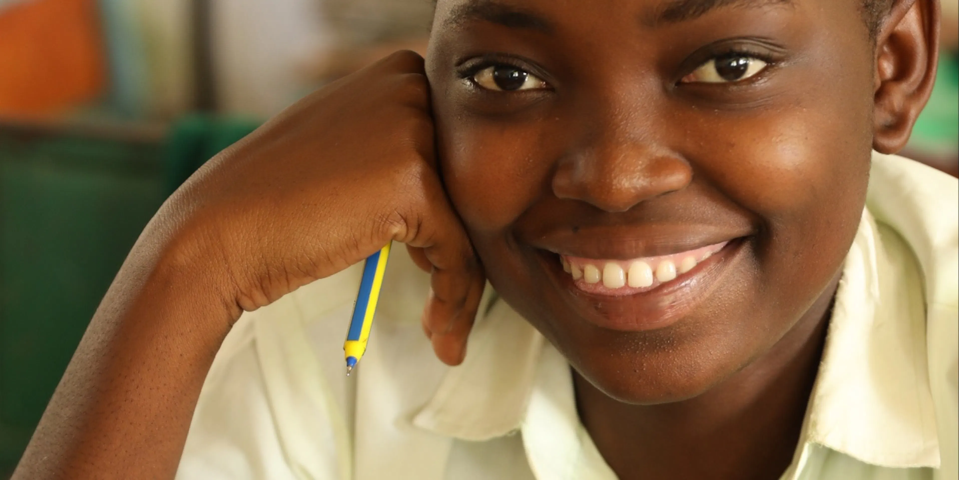Student resting her chin on her hand beside an open notebook