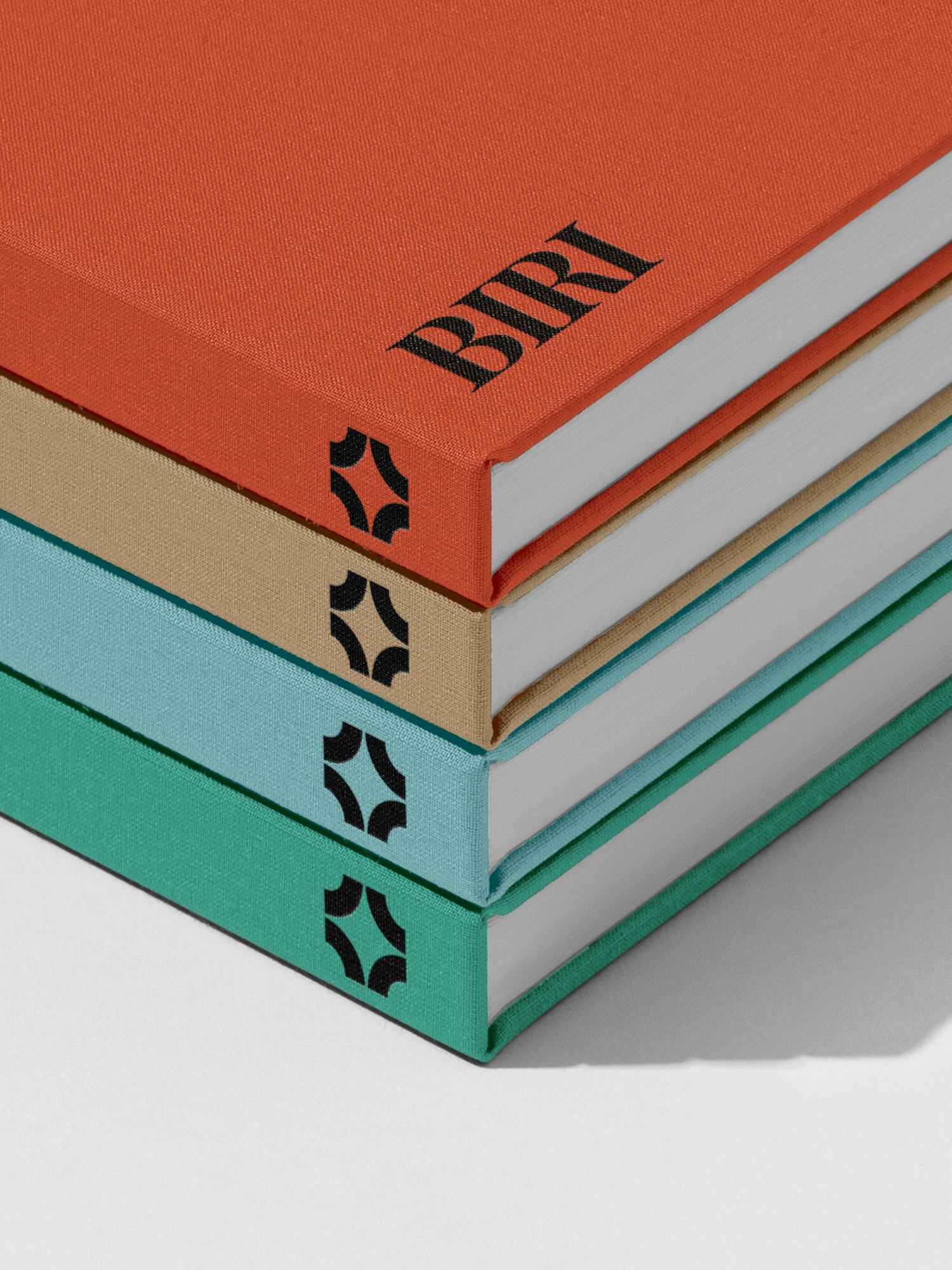 A stack of notebooks or books featuring the BIRI logotype and marque.
