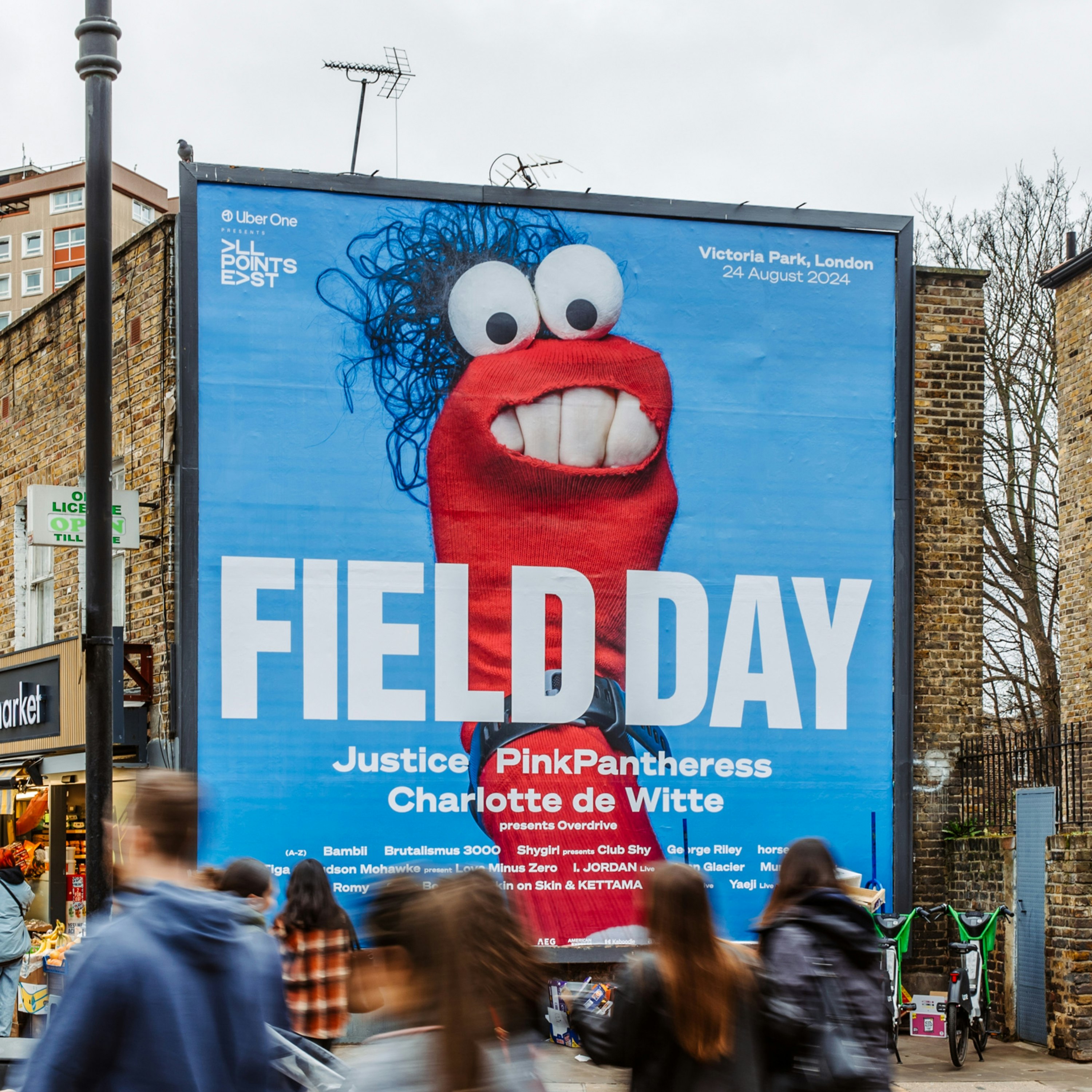 A large billboard advertising Field Day, featuring a red puppet on a blue background.