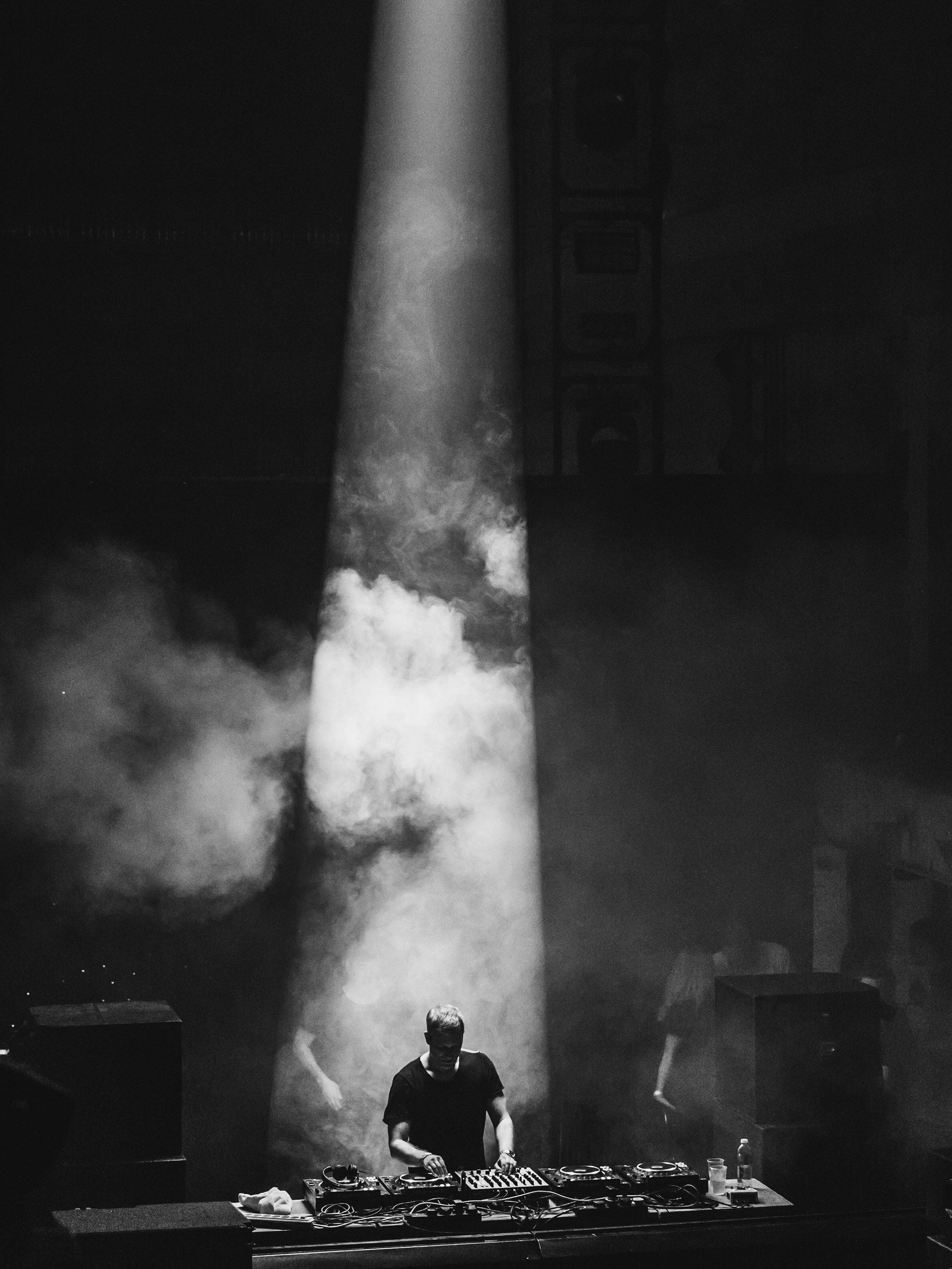 DJ performing under a narrow spotlight at Printworks London.