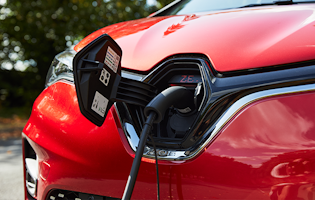 Electric charger plugged into a red Renault Zoe