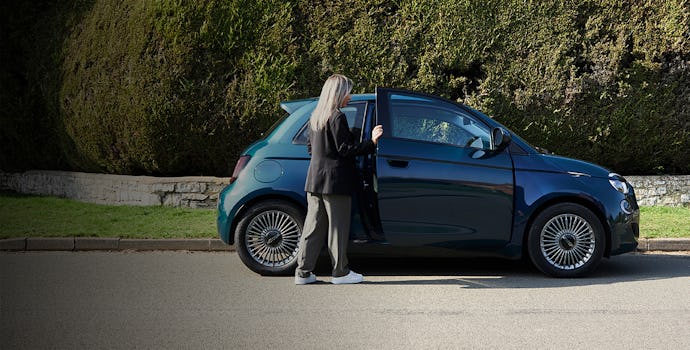 A woman getting into a Fiat 500 Electric Icon 