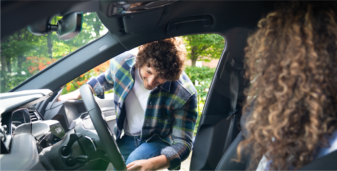 Man getting into his electric car image