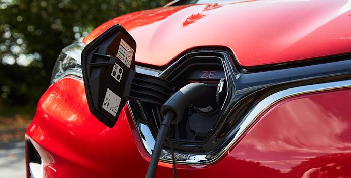 Electric charger plugged into a red Renault Zoe