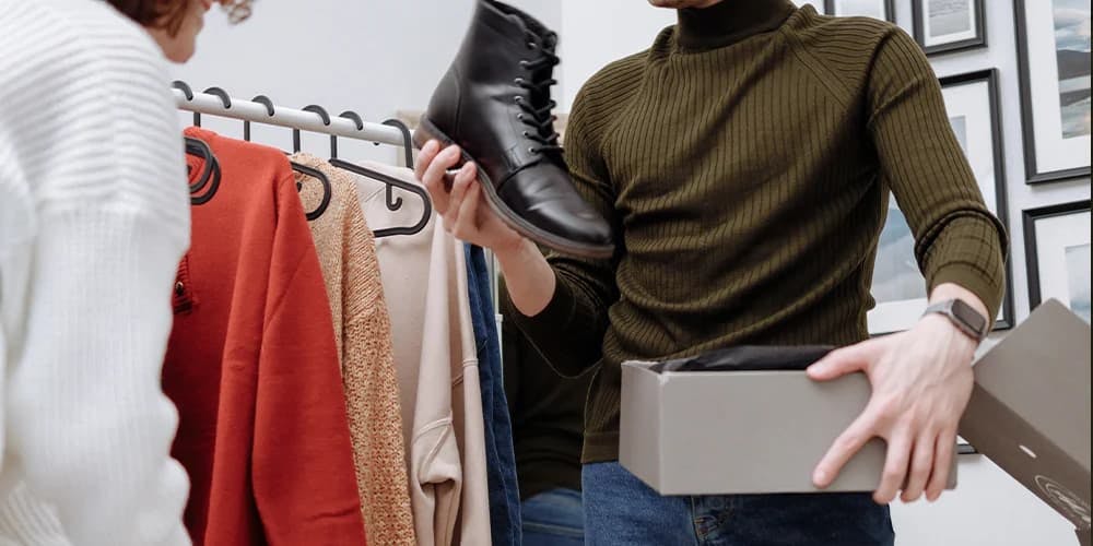 Man assisting a woman in a shoe shop, helping her find the perfect pair