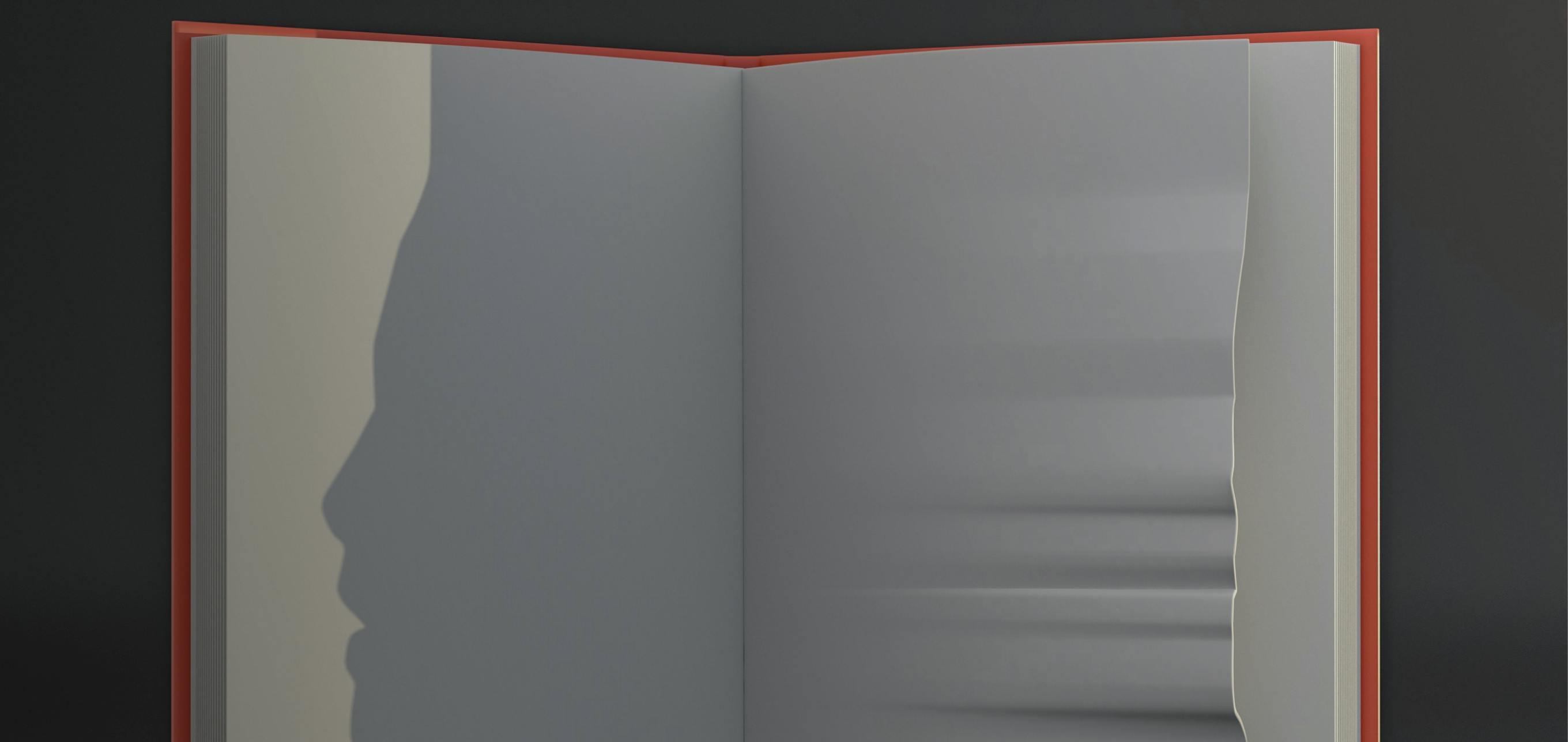 Kitap üzerine gölgesi yansıyan kişi resmi