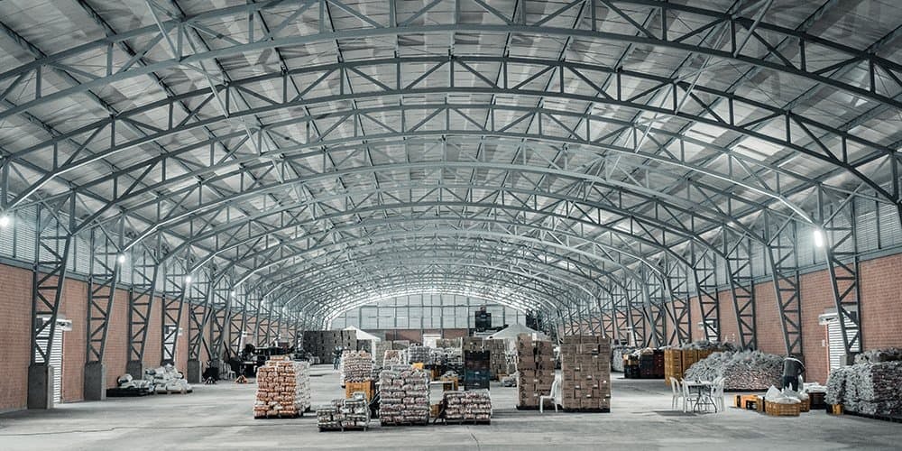 Newly organized warehouse with neatly stacked boxes and shelves