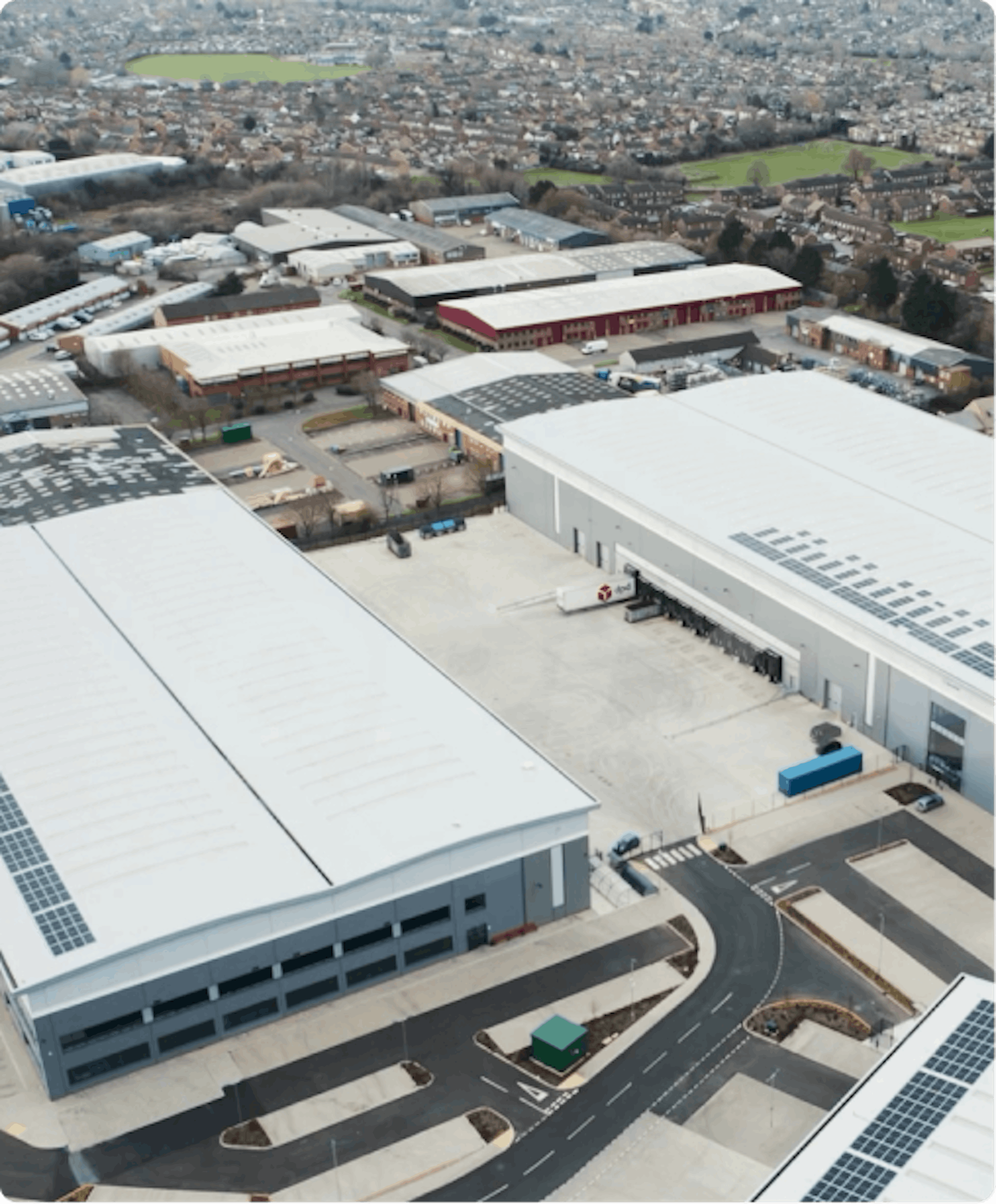overhead view of a two buildings with a city behind