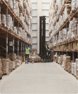 man standing next to lift in a warehouse