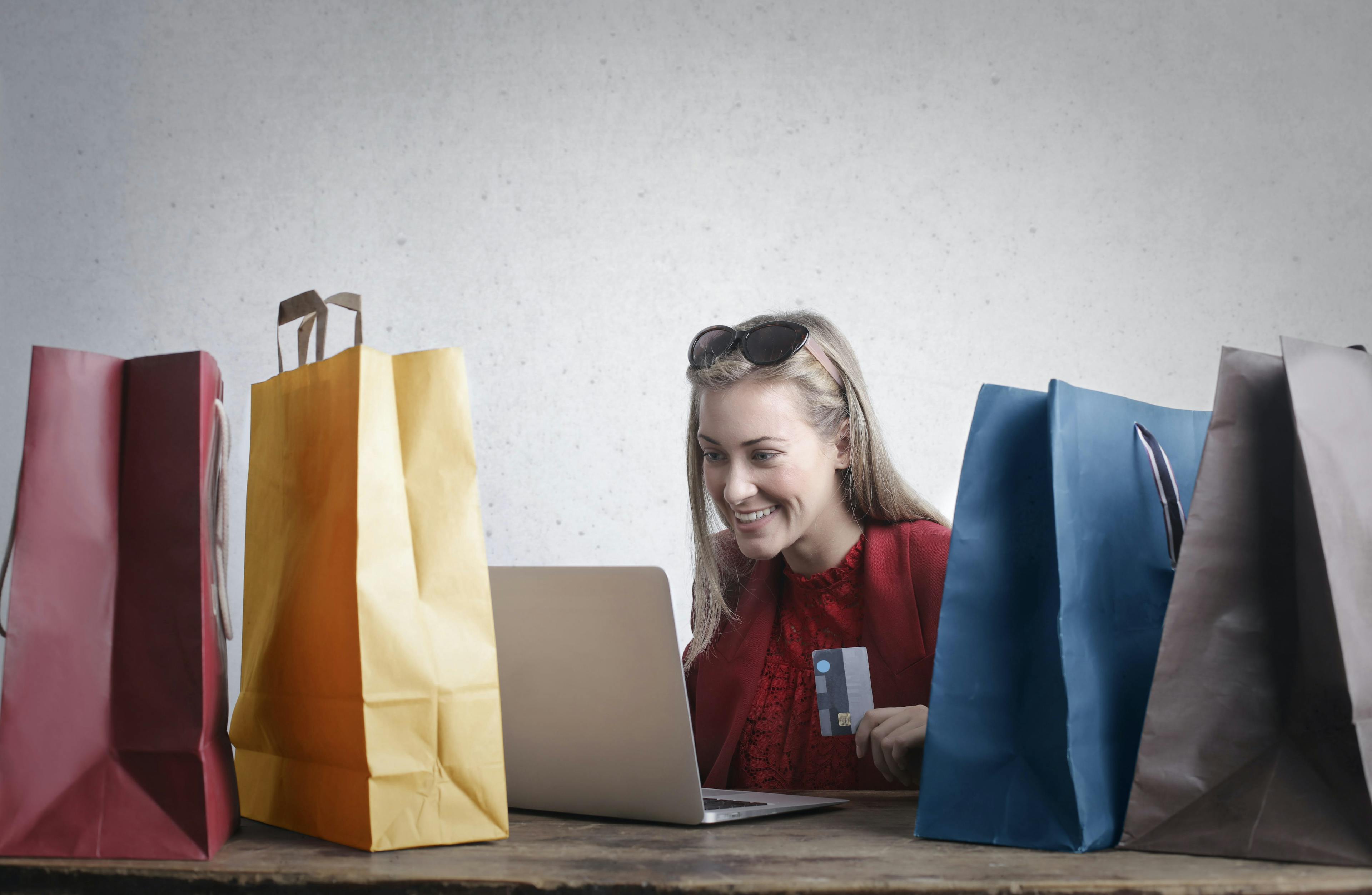 woman shopping online with ecommerce, packs on the table