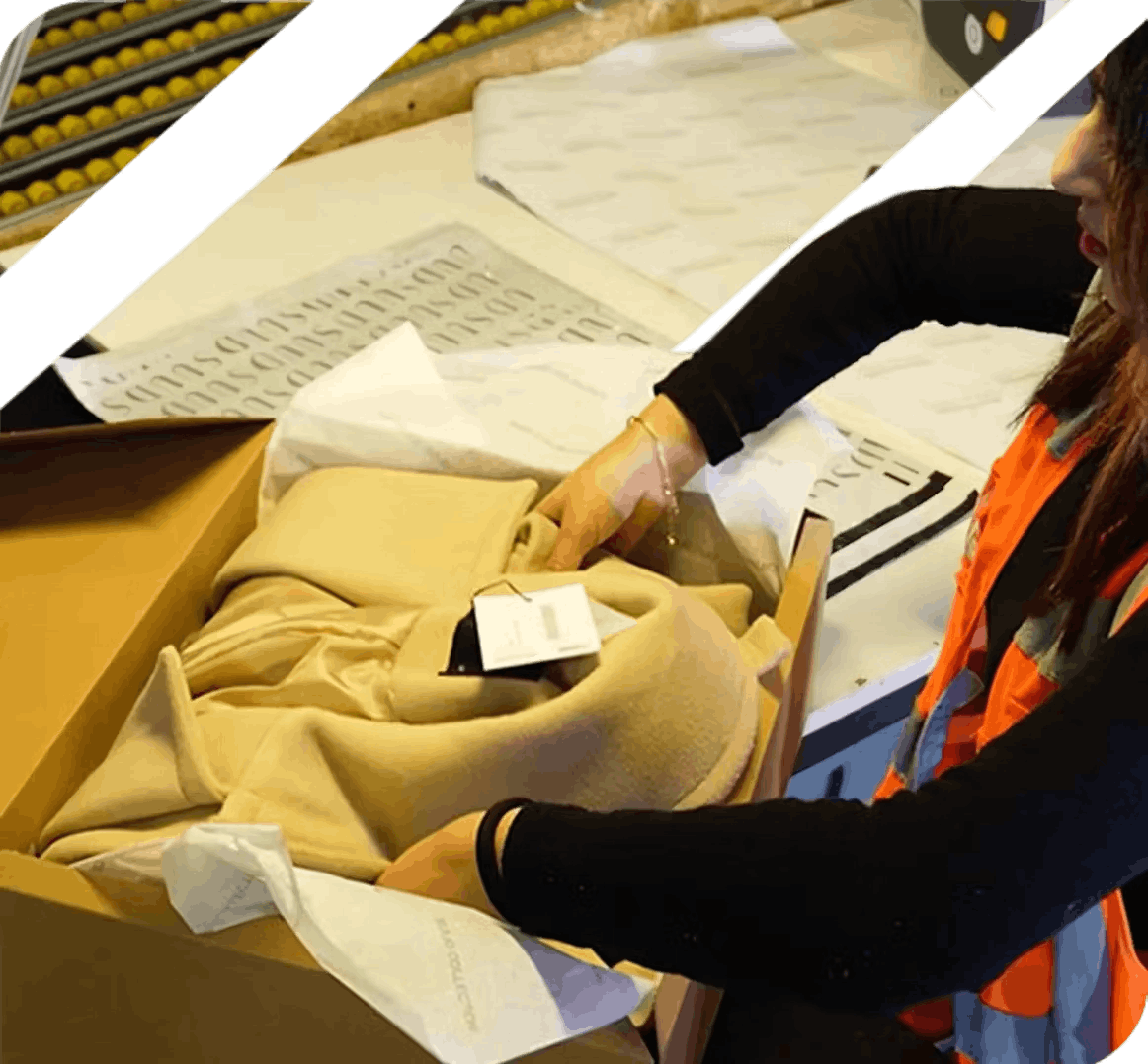 Quality control worker inspecting packaged clothing items