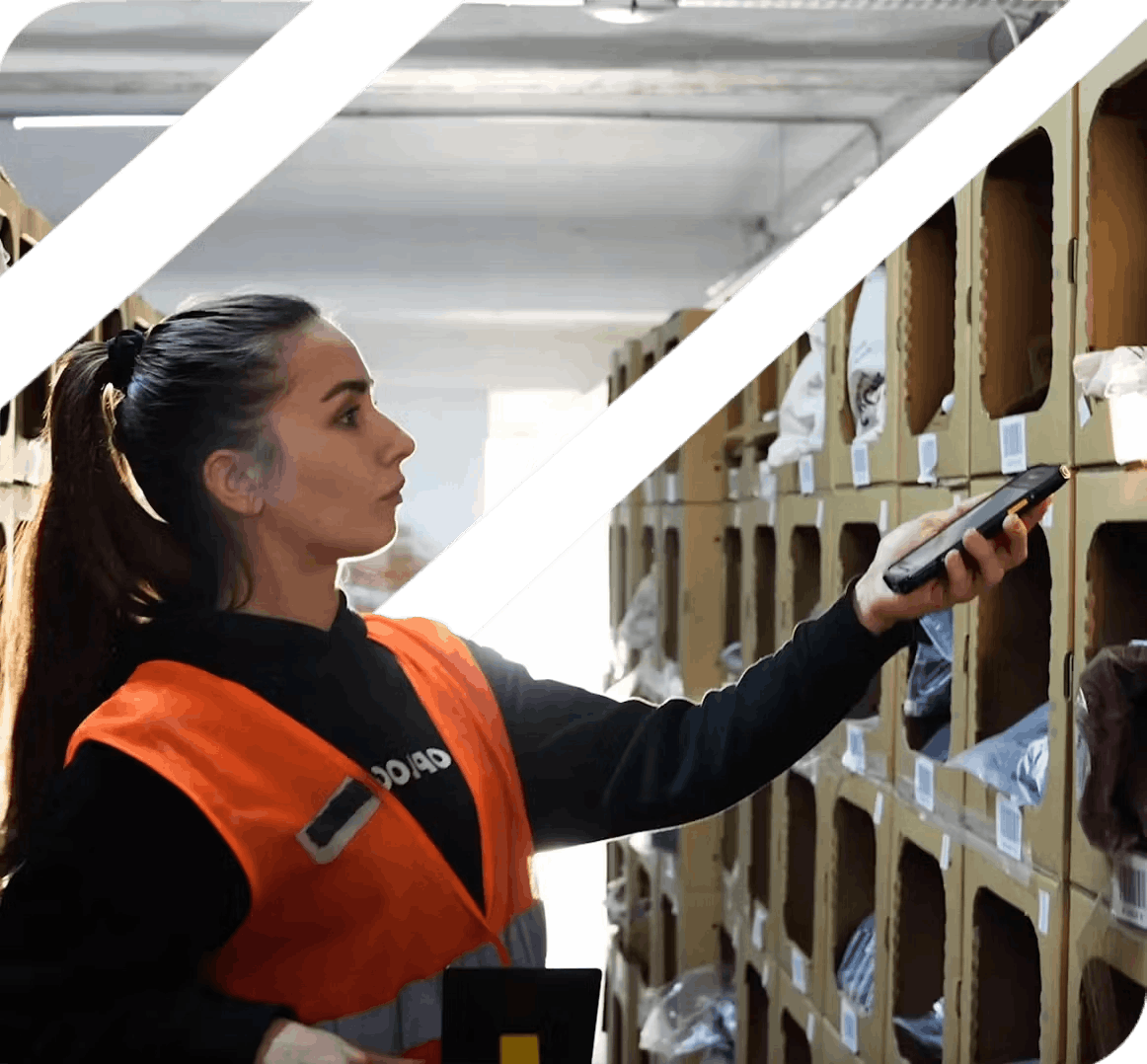 Warehouse worker scanning inventory with handheld device