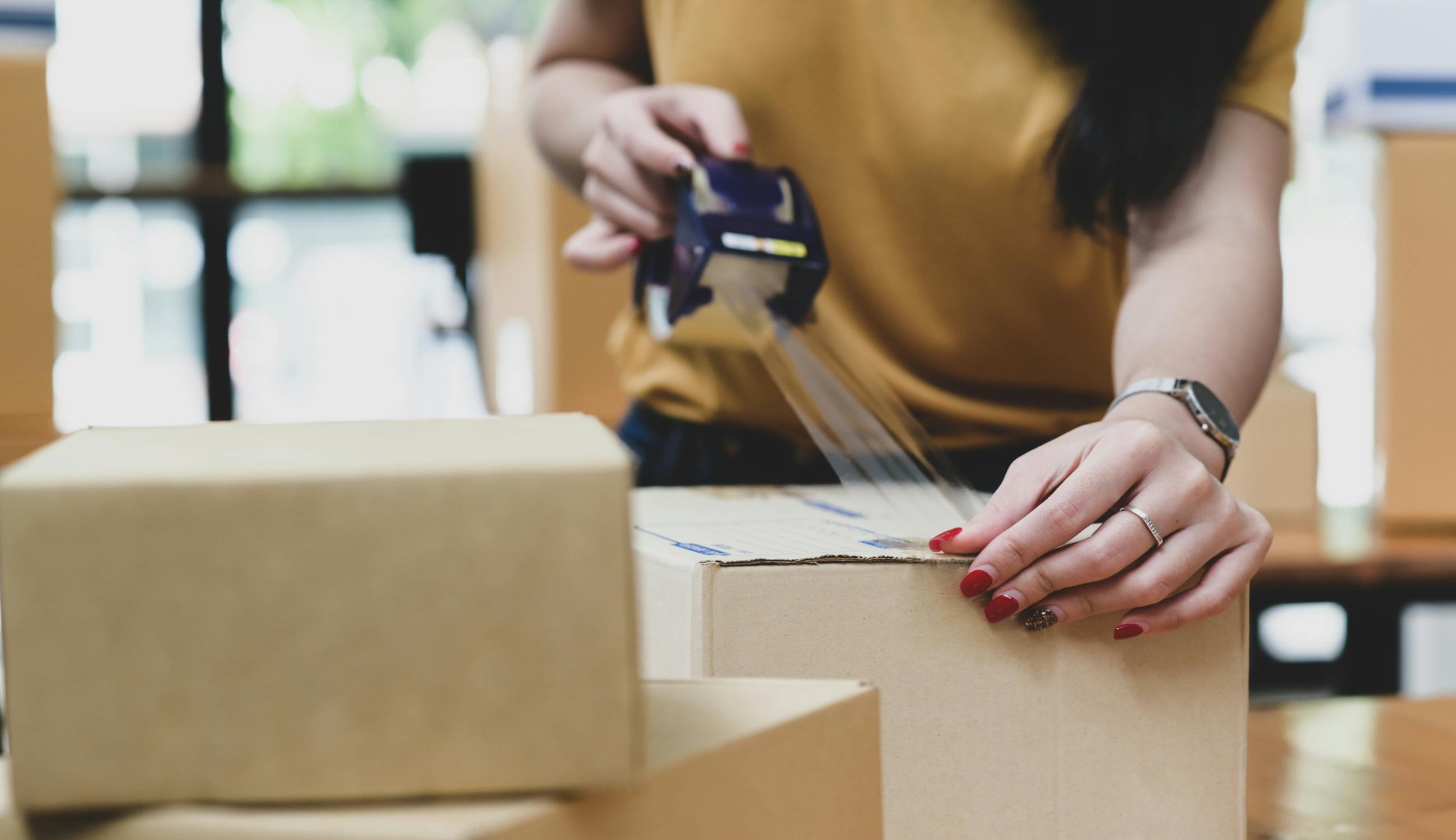 A women is sealing the kitting boxes