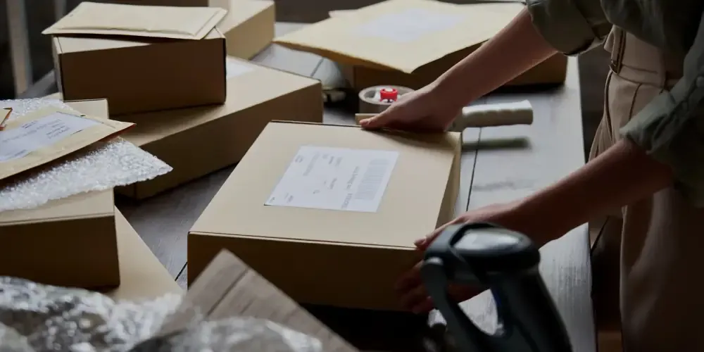 Woman engaged in packaging operations in a small warehouse