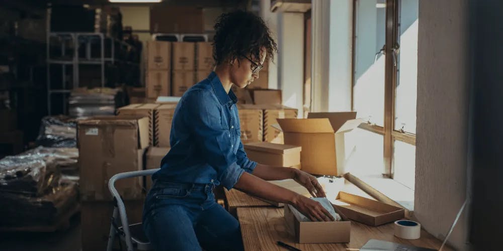 a woman packing boxes