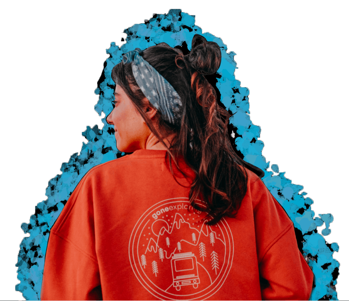 Person wearing a red Gone Exploring sweatshirt with outdoor design on blue background