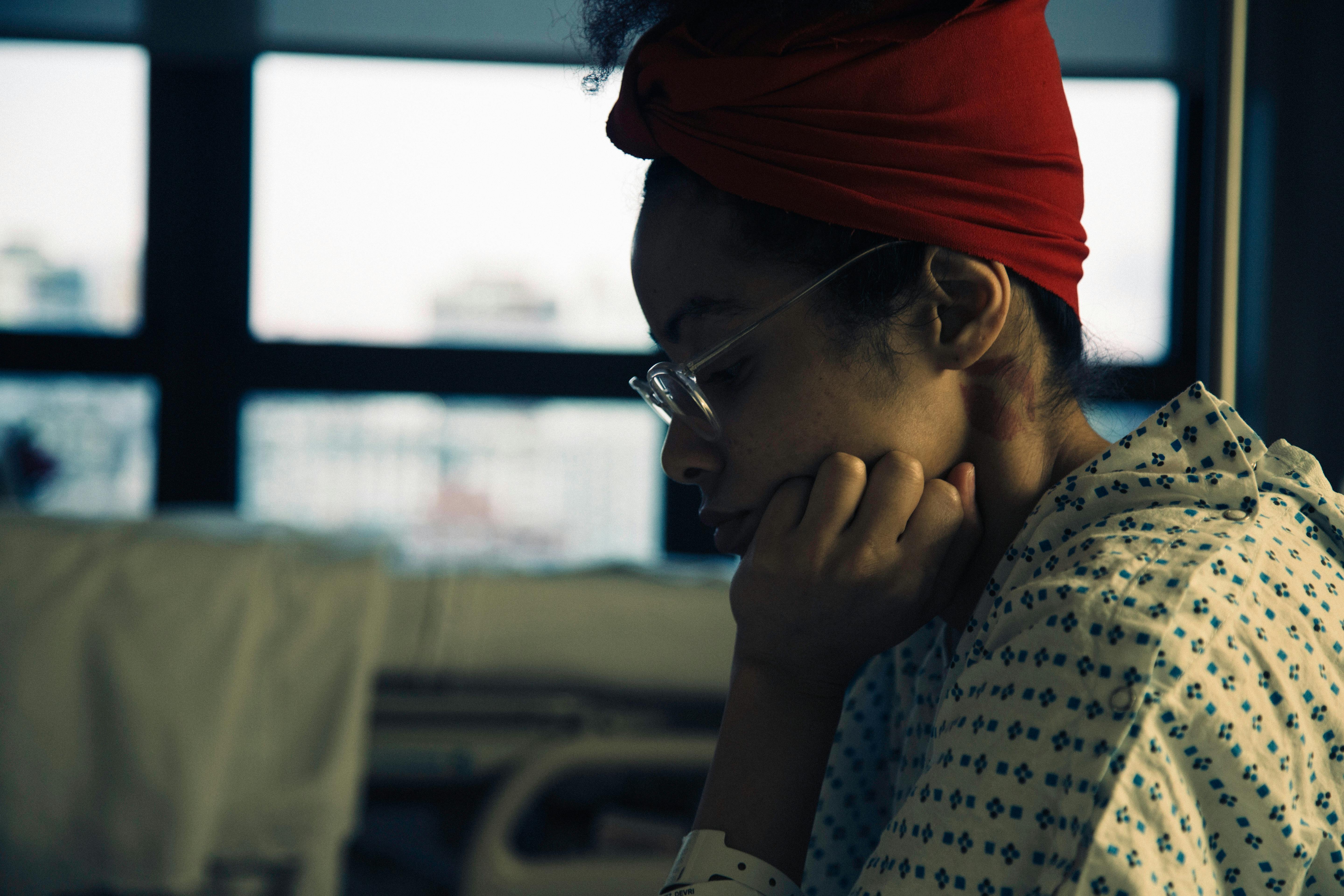 Devri Velazquez patient in hospital wearing hospital gown