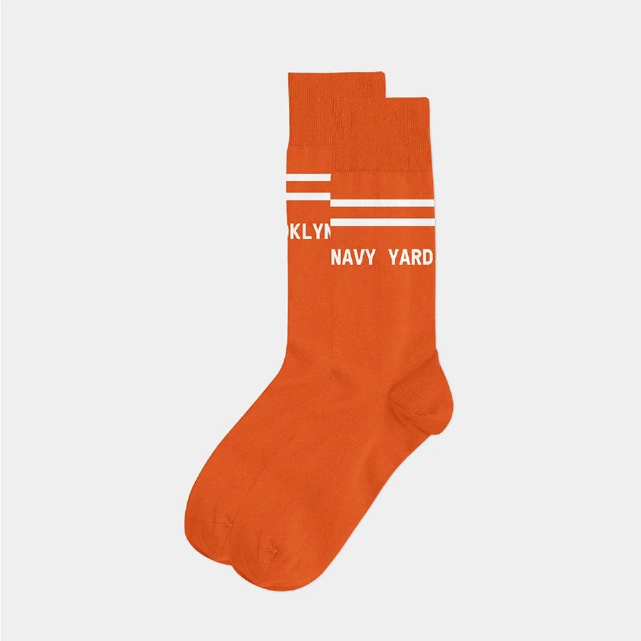 Orange socks swag with Brooklyn Navy Yard's signature text