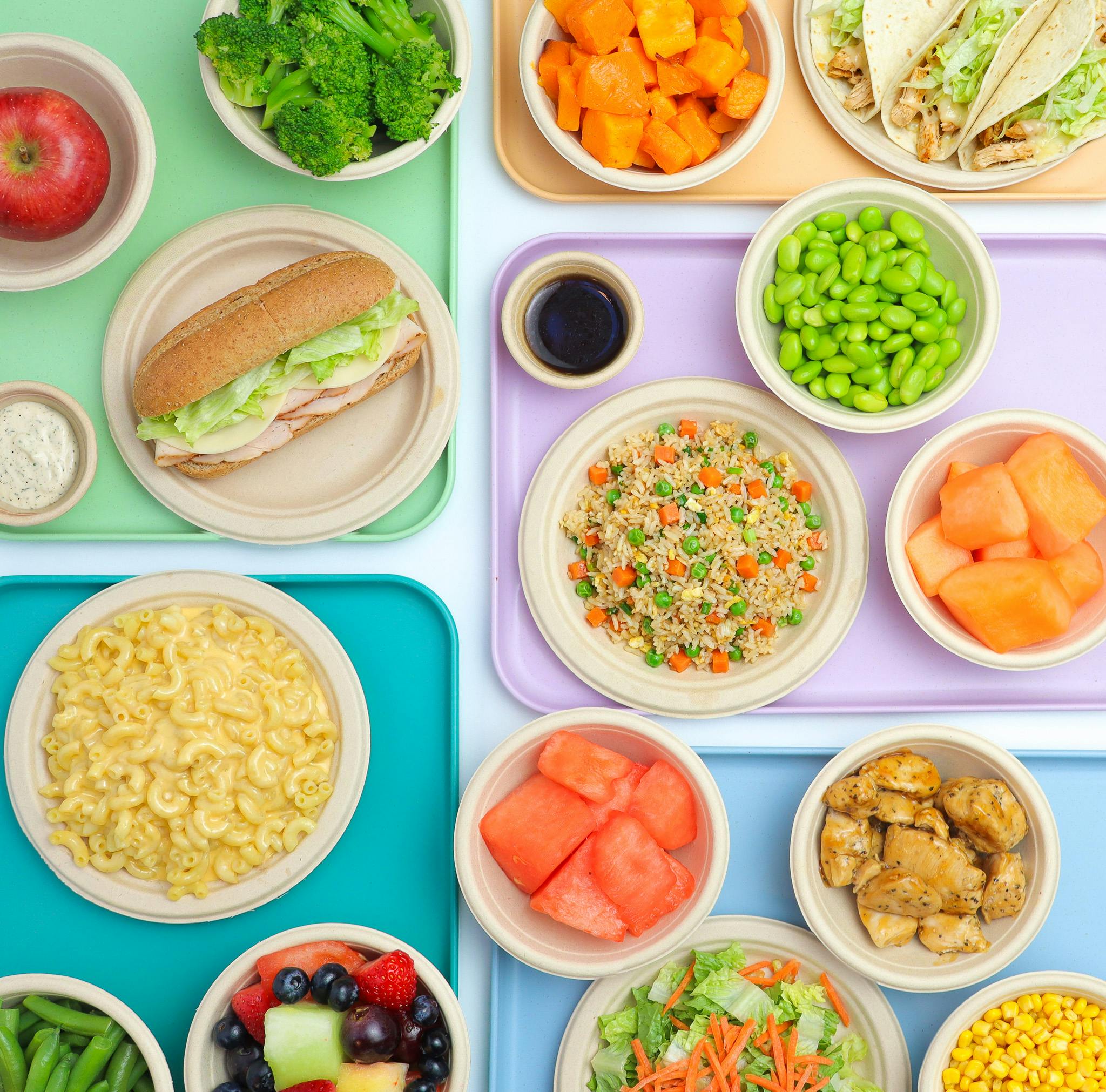 Assorted cafeteria trays with bright, fresh food