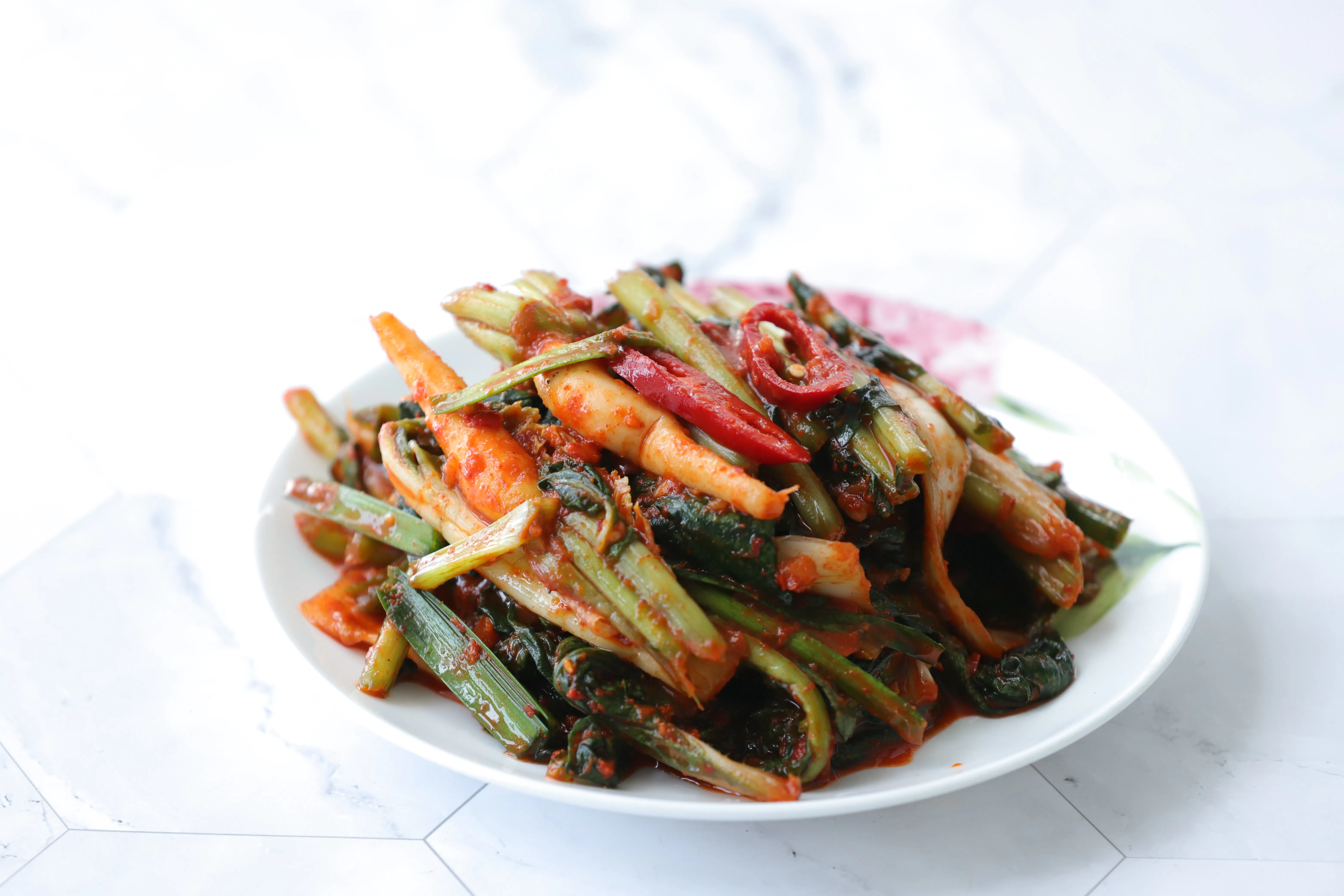 Pickled kimchi on a white dish.
