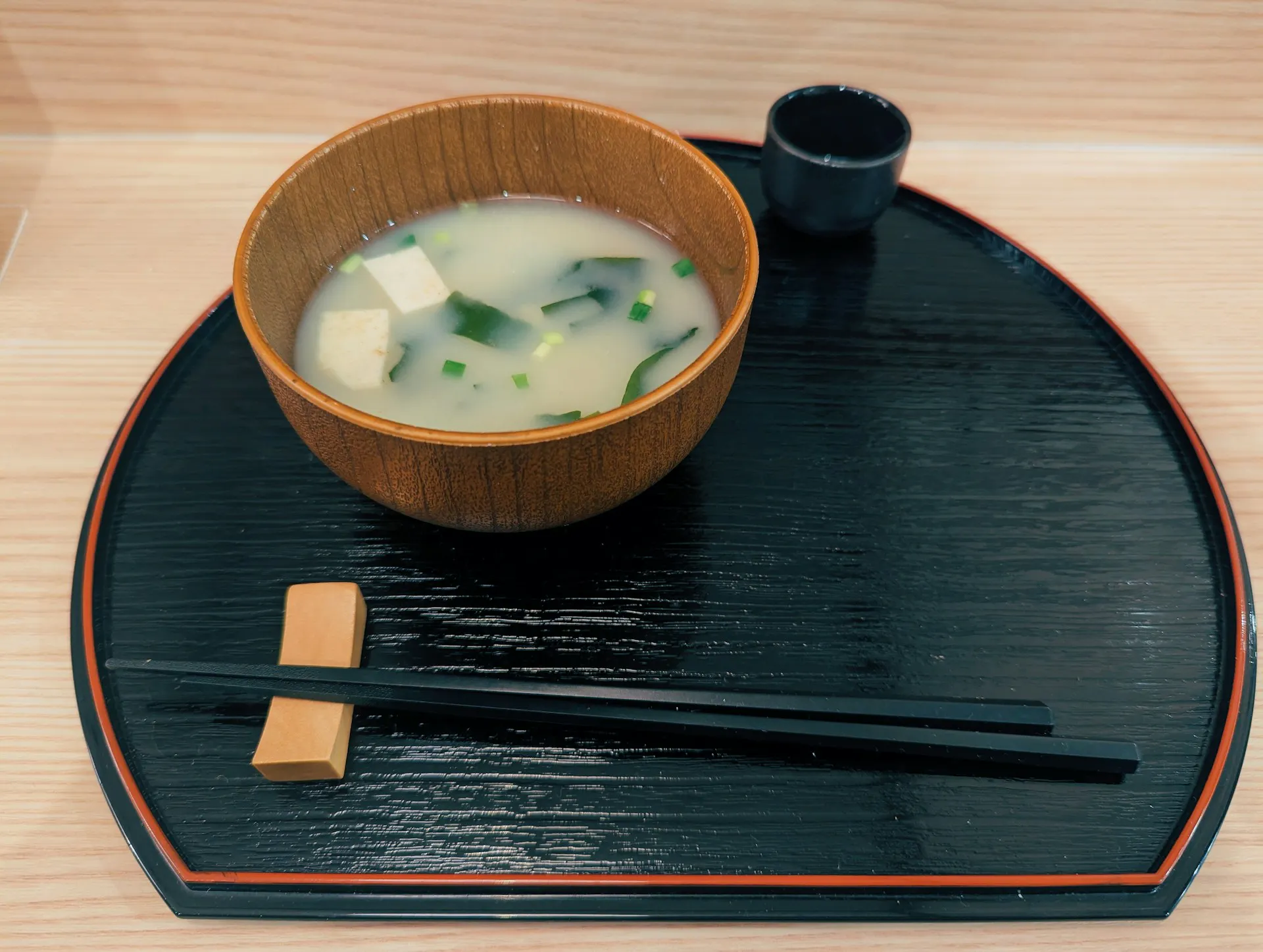 Miso soup in bowl with chopsticks