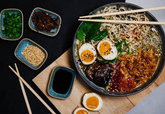 A bowl of ramen and different toppings 