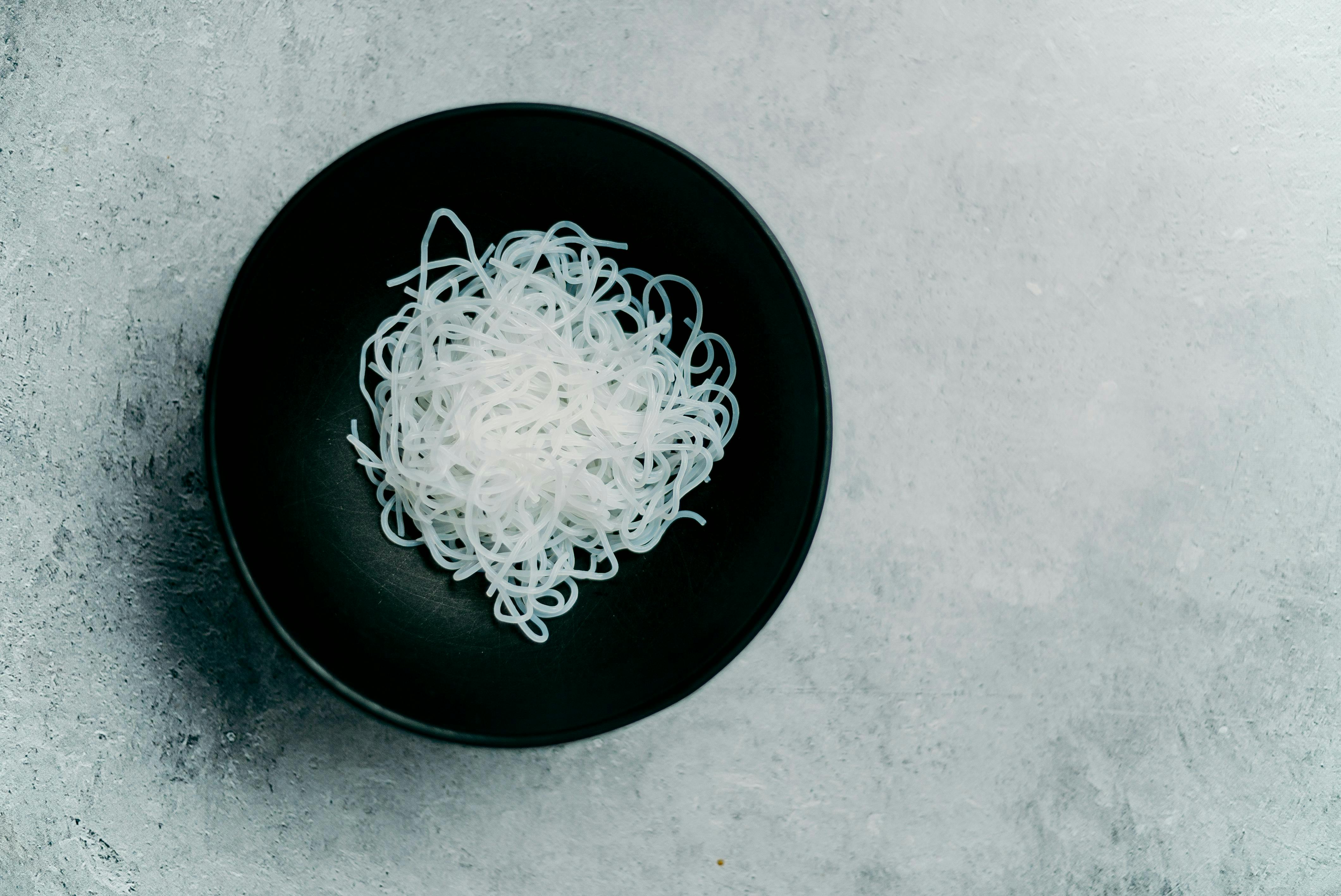 Vegan rice noodles in a black bowl