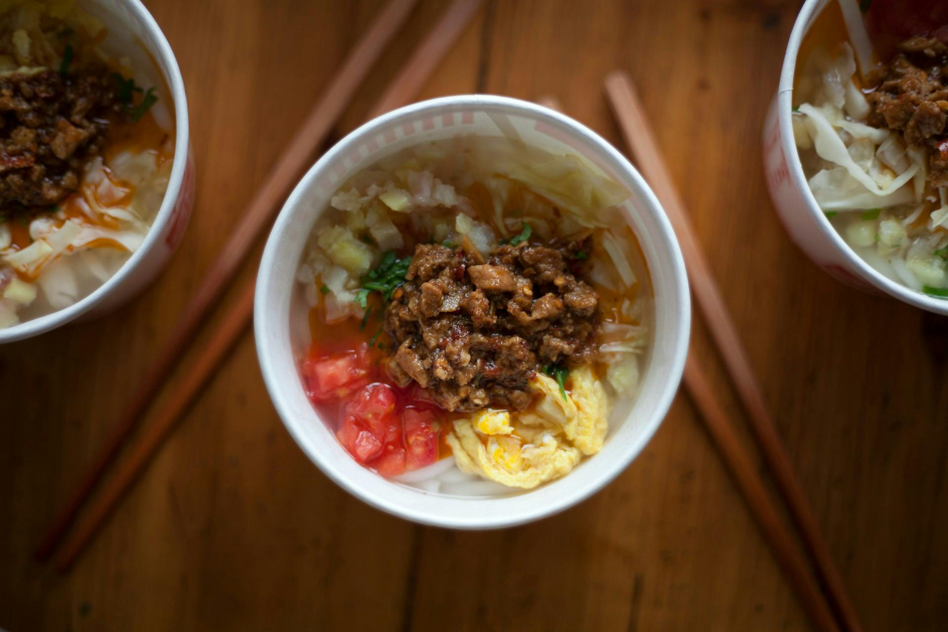 a cup of instant noodles with meat