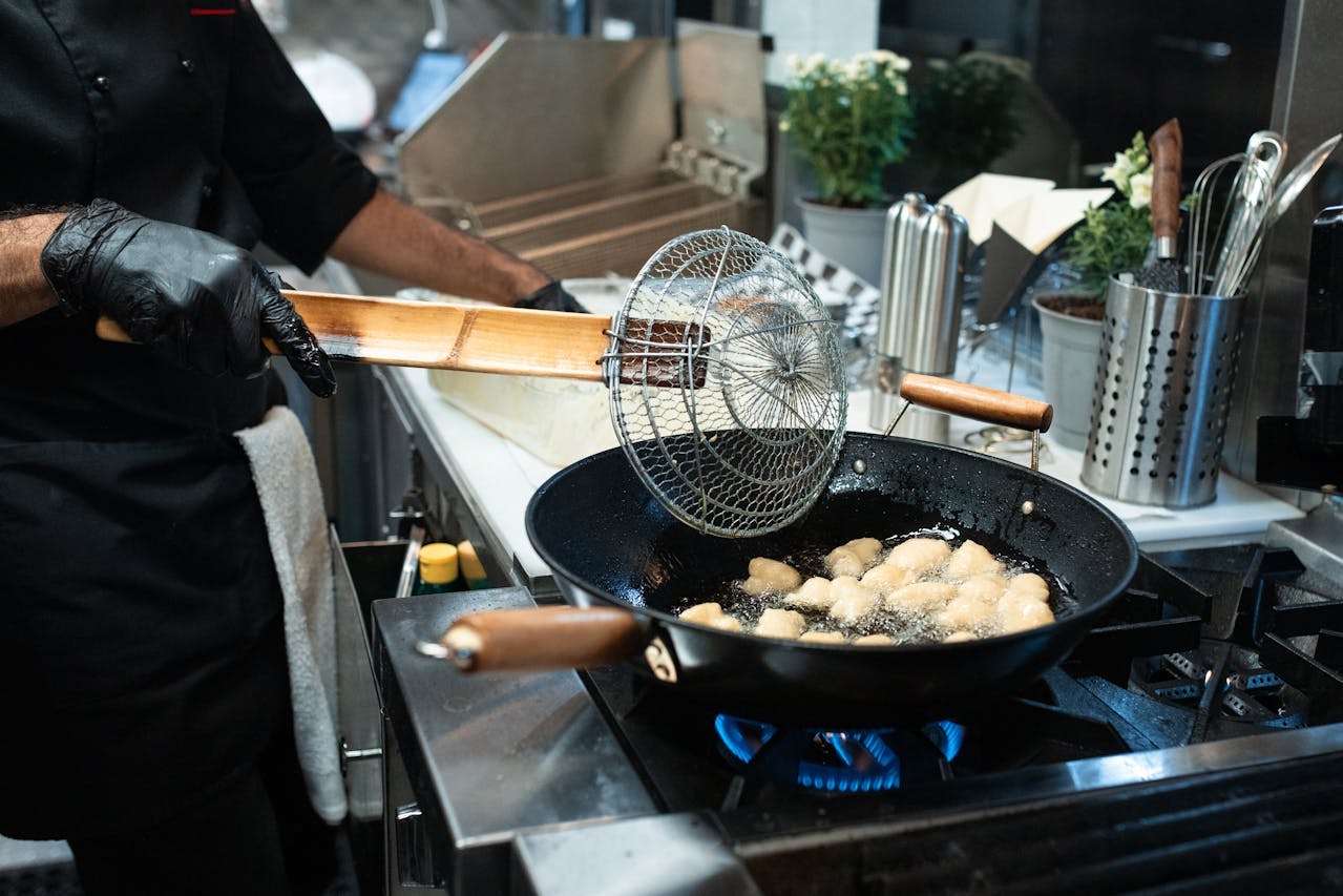 a chef frying with oil