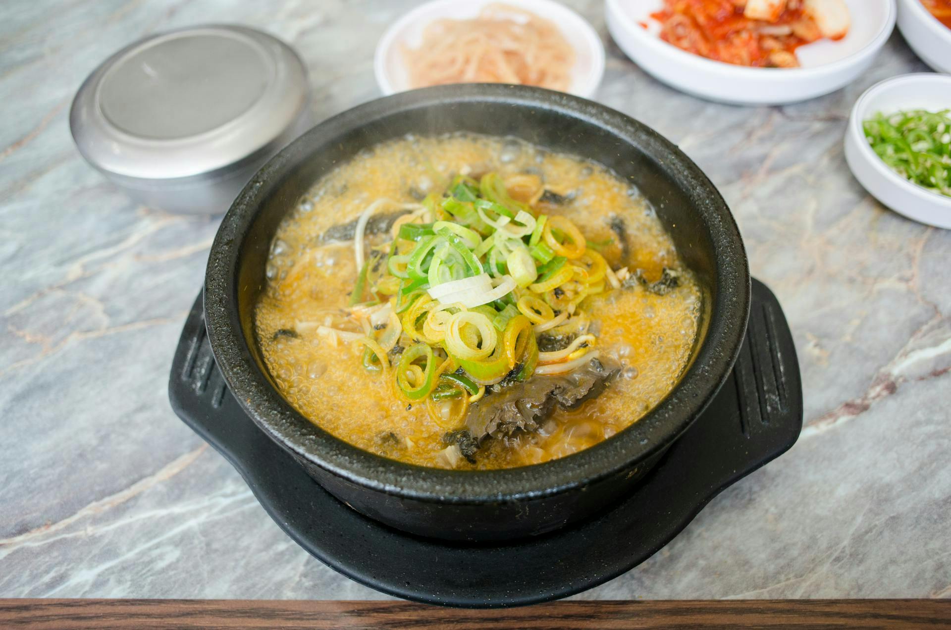 a hot pot with soup and ingredients