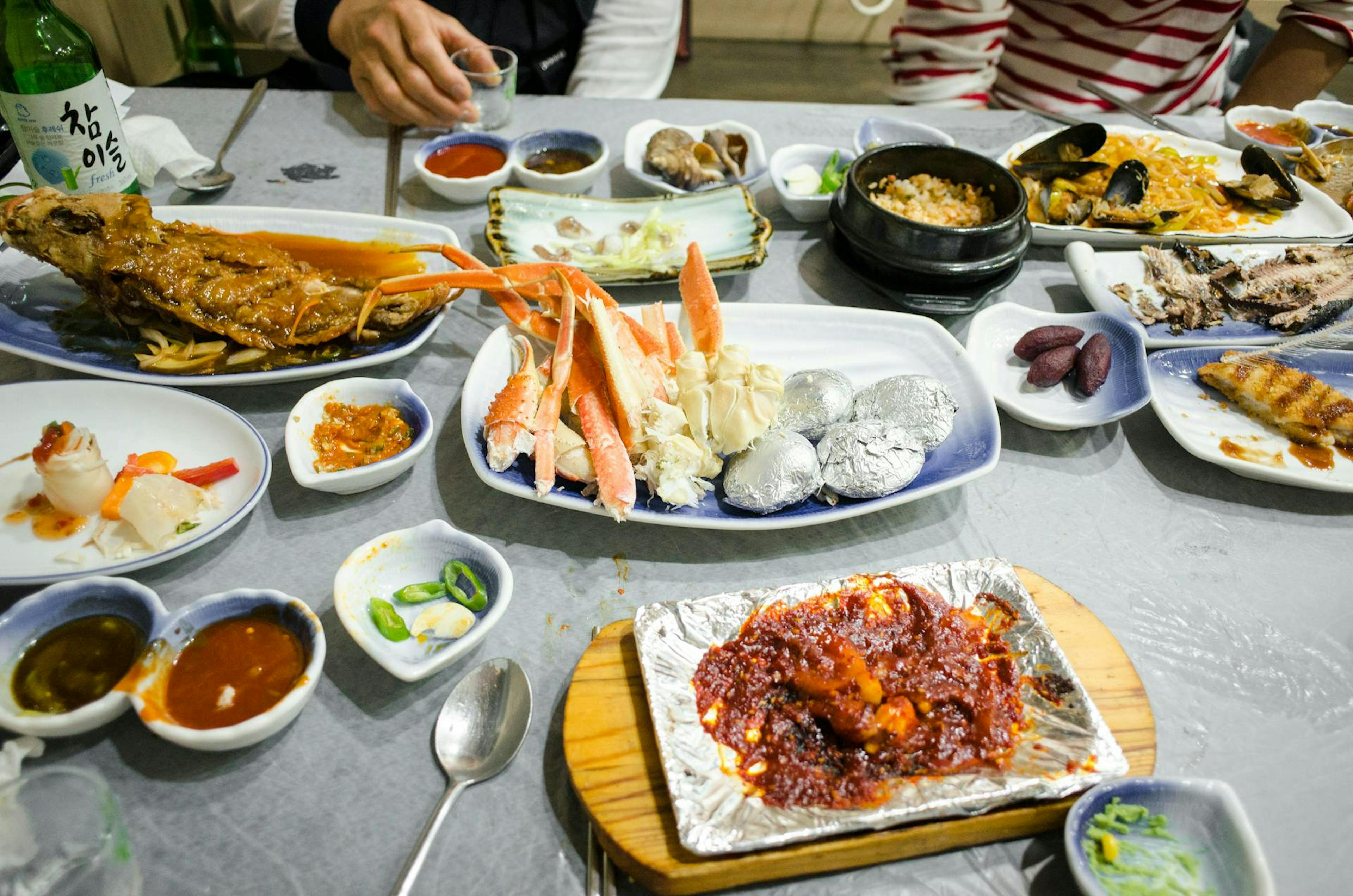 a restaurant table filled with Korean food