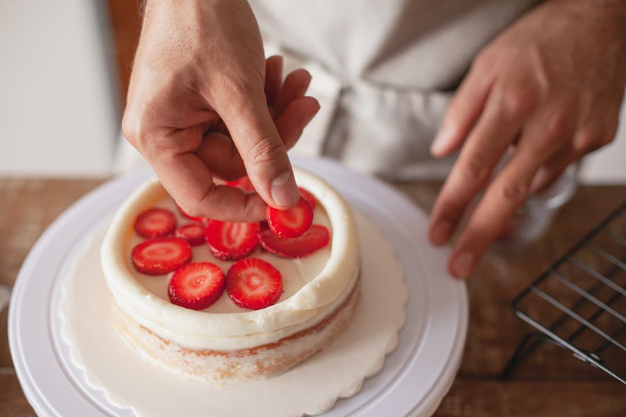 Someone making a strawberry cake