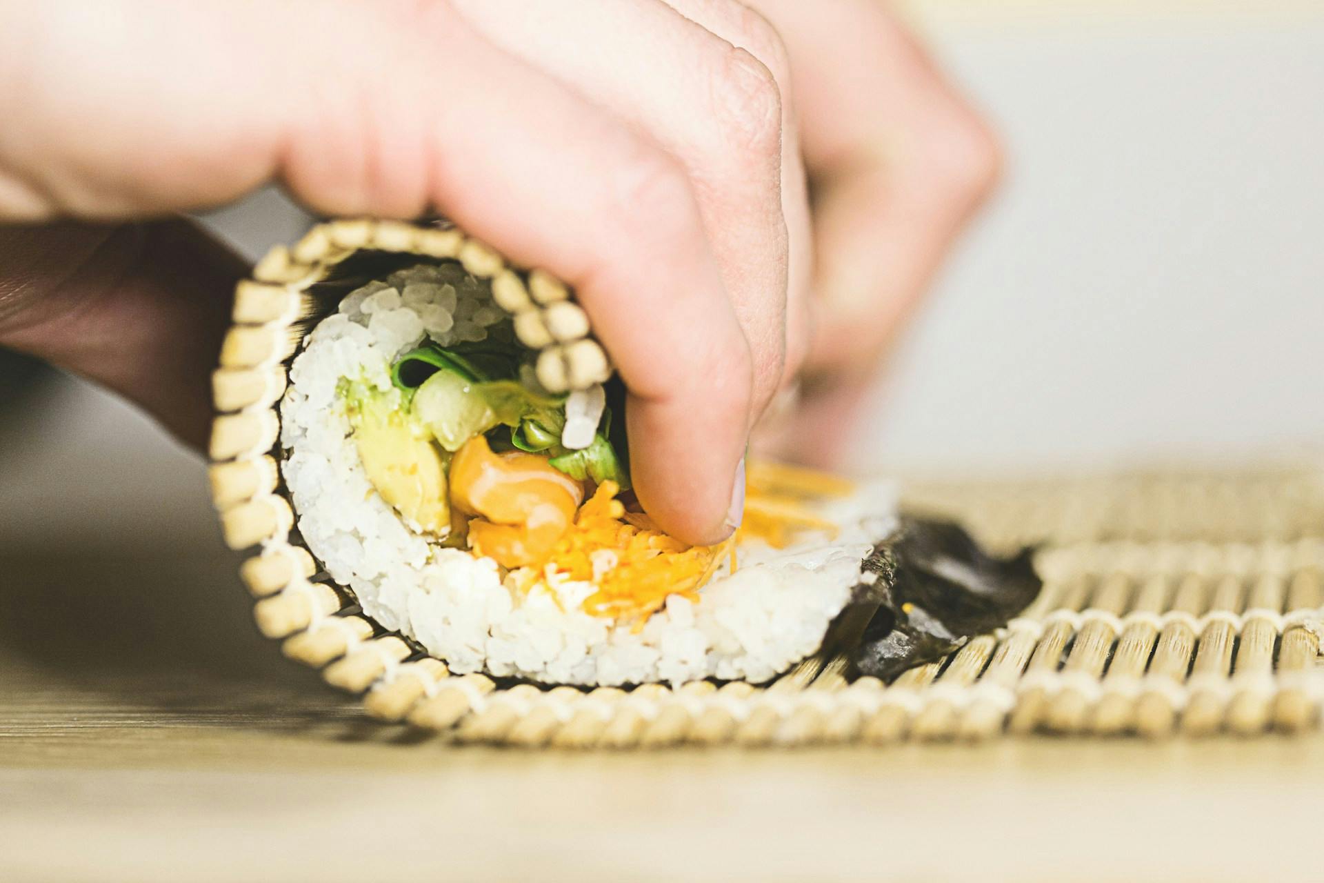 rolling sushi with a bamboo mat