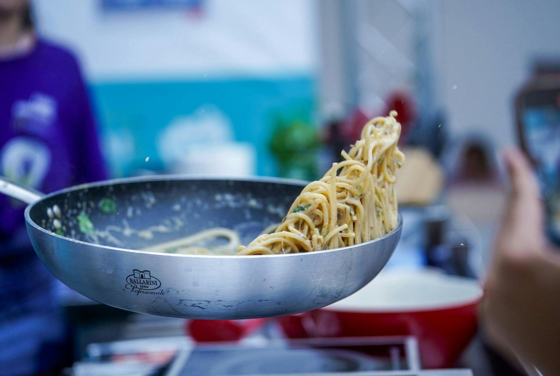 Noodles being tossed in a wok